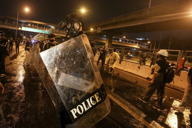 Police react with protesters during a protest in Bangkok, Thailand, Sunday, February 28, 2021. (Photo by AP Photo/Stringer)