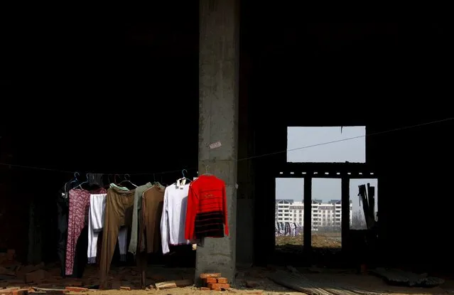 Clothes hang from a line in a residential building under construction in the town of Gushi in Henan Province, in this March 28, 2010 file photo. (Photo by David Gray/Reuters)