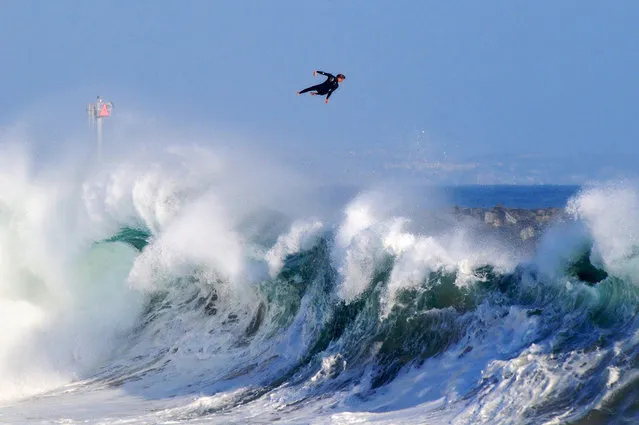 Photographer: Benjamin Ginsberg. Athlete: Bobby Okvist. Location: The Wedge, Newport Beach, California. (Photo by Benjamin Ginsberg/Red Bull Illume via The Atlantic)