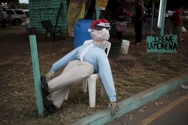 A handmade puppet is seen along the street in Managua, Nicaragua December 30, 2015. Nicaraguans traditionally burn handmade puppets as a way of saying goodbye to the old year and welcoming in the new. (Photo by Oswaldo Rivas/Reuters)