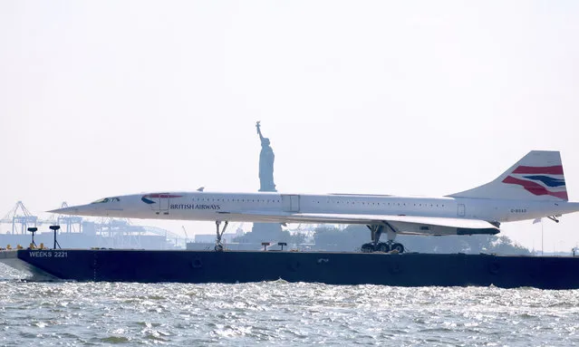 The British Airways Concorde from the Intrepid Museum on the way for restoration on August 9, 2023. The supersonic jet sails down the Hudson River on a barge and passing by The Statue of Liberty and Brooklyn Bridge in New York, NY on August 9, 2023. (Photo by Guerin Charles/ABACA Press/Rex Features/Shutterstock)