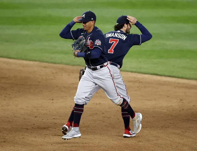 Atlanta Braves third baseman Ehire Adrianza of Venezuela (L) celebrates with teammate Atlanta Braves shortstop Dansby Swanson (R) after their team defeats the New York Yankees during their MLB game at Yankee Stadium in the Bronx, New York, USA, 21 April 2021. (Photo by Jason Szenes/EPA/EFE)