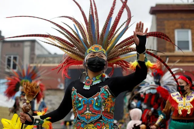 Ketzal Coatlicue Aztec dancers perform during the 'Earth Day' celebration, moved ahead to April 24 to fall on Saturday, just days after former Minneapolis police officer Derek Chauvin was found guilty of killing George Floyd in May 2020, in Minneapolis, Minnesota, U.S., April 24, 2021. (Photo by Octavio Jones/Reuters)