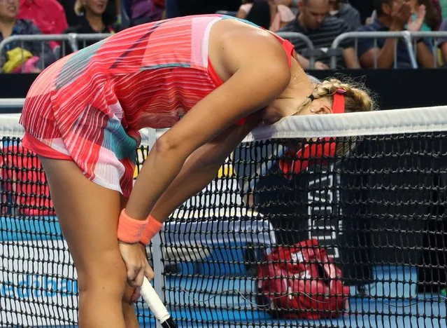 Kristina Mladenovic of France bites the net in frustration after missing a shot against Daria Gavrilova of Australia during their third round match at the Australian Open tennis championships in Melbourne, Australia, Friday, January 22, 2016. (Photo by Rick Rycroft/AP Photo)