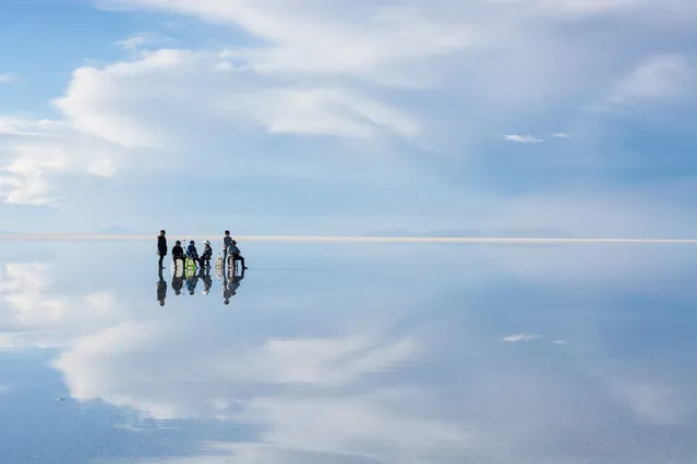 Explorers appear to stand on water at the salt flats of Bolivia. (Photo by Hideki Mizuta/Caters News Agency)