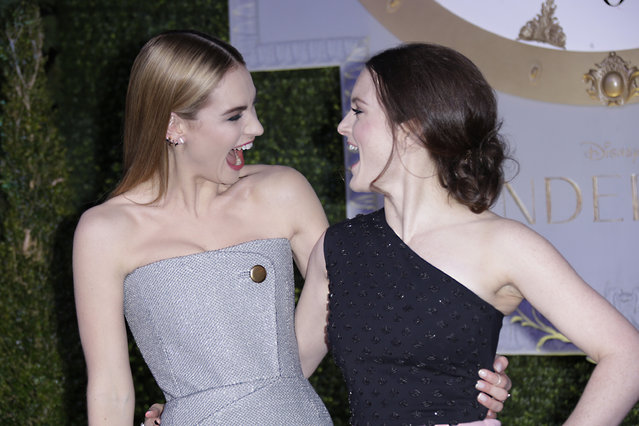 Lily James and Sophie McShera share a joke upon arrival at the premiere of the film Cinderella in London, Thursday, 19 March, 2015. (Photo by Joel Ryan/Invision/AP Photo)