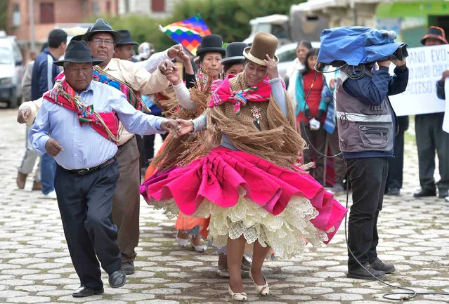 Residents dance during an inauguration ceremony for water service in Huatajata, on the shores of Titicaca lake, Bolivia December 25, 2016. (Photo by Freddy Zarco/Reuters/Courtesy of Bolivian Presidency)