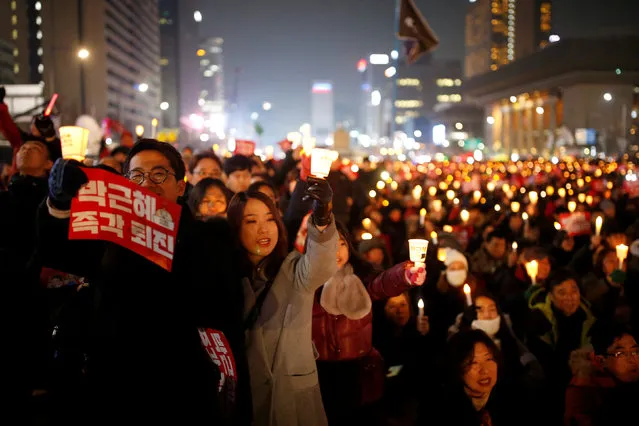 People attend a protest demanding South Korean President Park Geun-hye's resignation in Seoul, South Korea, December 31, 2016. The sign reads “Step down Park Geun-hye immediately”. (Photo by Kim Hong-Ji/Reuters)
