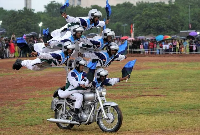 Indian army soldiers display their skills on motorcycles on the eve of Independence Day  in Hyderabad, India, Sunday, August 14, 2022. (Photo by Mahesh Kumar A./AP Photo)