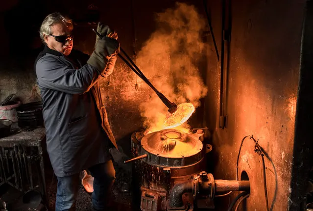 Serge Serge Huguenin founds a bell in his foundry “Fonderie Blondeau” in Chaux-de-Fonds, canton of Neuchatel, Switzerland, 03 January 2017. The “Fonderie Blondeau” is specialized in the making of the traditional Swiss bells. (Photo by Jean-Christophe Bott/EPA)