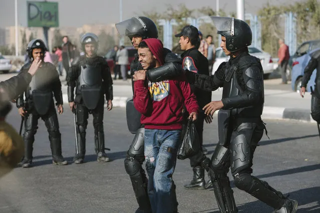 A supporter of Egypt's Muslim Brotherhood is arrested by Egyptian riot police after taking part in a small protest prior to the planned trial of deposed Egyptian President Mohammed Morsi at the Cairo Police Academy on January 8, 2014 in Cairo, Egypt. (Photo by Ed Giles/Getty Images)