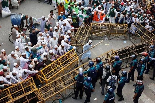 Members of the Islami Andolan Bangladesh, a political party, try to remove barricades as they join in a mass protest march towards the Election Commission, ahead of the election schedule declaration, in Dhaka, Bangladesh on November 15, 2023. (Photo by Mohammad Ponir Hossain/Reuters)