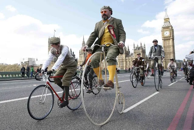 Participants in the Tweed Run ride their bicycles over Westminster Bridge in central London April 18, 2015. The Tweed Run is an annual event in which the participants wear vintage clothing and ride their bicycles though city centres worldwide. (Photo by Suzanne Plunkett/Reuters)