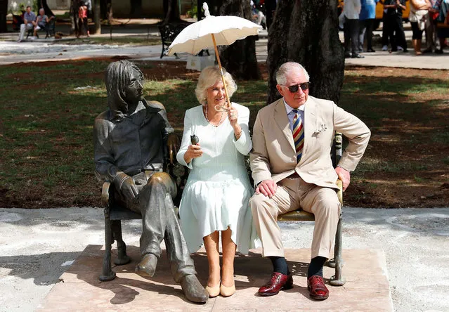 Britain's Prince Charles and Camilla, Duchess of Cornwall sit on a bench at John Lennon Park in Havana, Cuba on March 26, 2019. (Photo by Phil Noble/Reuters)