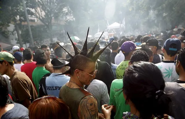 Protesters smoke marijuana during a demonstration in support of the legalization of marijuana in Medellin, May 2, 2015. (Photo by Fredy Builes/Reuters)