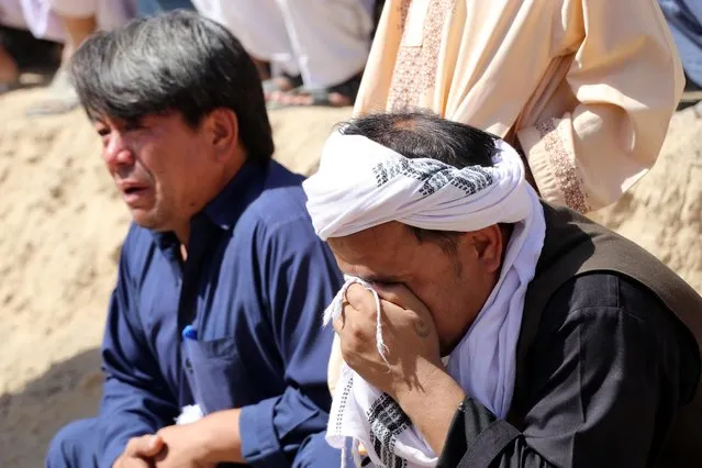 Relatives attend the funeral of the victims a day after a bomb blast during Friday prayers at Shiite Muslims Mosque in Kandahar, Afghanistan, 16 October 2021. At least 32 people died, and many others suffered injuries in a powerful explosion that ripped through a Shia mosque in the southern Afghan city of Kandahar during Friday prayers. The Islamic State has carried out numerous attacks, in recent years, against the Shia minority, especially the Hazaras. The Taliban have launched massive operations against the Islamic State in different Afghan provinces, aiming to finish a group that they consider the main threat to their government. (Photo by EPA/EFE/Stringer)