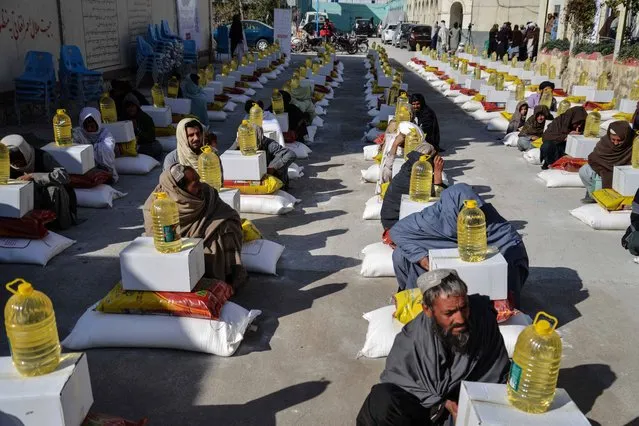Afghan refugees deported from Pakistan received food aid by the Red Cross Society in Kandahar on January 24, 2024. (Photo by Sanaullah Seiam/AFP Photo)