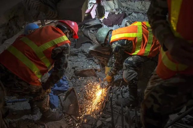 Nepal military personnel work inside a collapsed building in search of victims after the April 25 earthquake at Kathmandu in Nepal, May 7, 2015. (Photo by Athit Perawongmetha/Reuters)