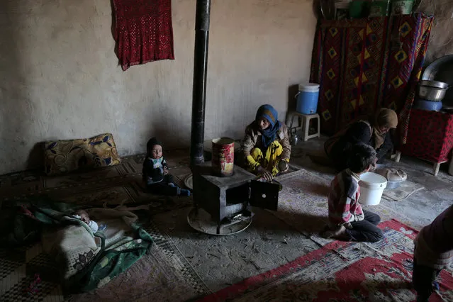 Residents of Bir Said village sit inside a home, after their return to the village when Syrian Democratic Forces took control of the area from Islamic State militants in northern Raqqa province, Syria February 7, 2017. (Photo by Rodi Said/Reuters)