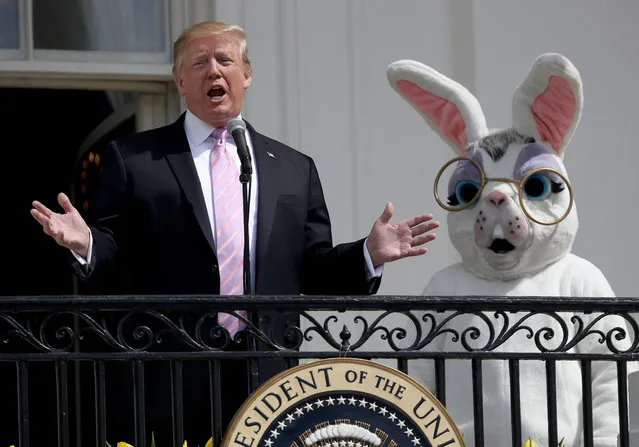 U.S. President Donald Trump, accompanied by a person dressed as the Easter Bunny, welcomes guests with opening remarks during the 141st Easter Egg Roll on the South Lawn of the White House April 22, 2019 in Washington, DC. About 30,000 people are expected to attend the annual tradition of rolling colored eggs down the South Lawn of the White House that dates back to the Rutherford B. Hayes Administration in 1878. (Photo by Win McNamee/Getty Images)