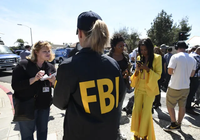 An FBI agent gives out information to members of the media outside of the Chabad of Poway Synagogue Saturday, April 27, 2019, in Poway, Calif. Several people were injured in a shooting at the synagogue. (Photo by Denis Poroy/AP Photo)