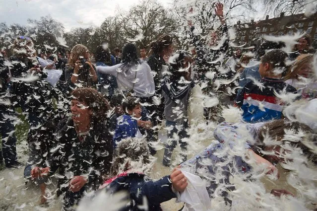 Revellers take part in a mass pillow fight in Kennington Park in south London on International Pillow Fight Day, April 2, 2016. (Photo by Niklas Halle'n/AFP Photo)