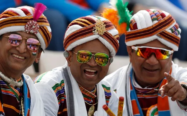 Indian cricket fans smile for the camera as they wait for the start of the Cricket World Cup match between South Africa and India at the Hampshire Bowl in Southampton, England, Wednesday, June 5, 2019. (Photo by Alastair Grant/AP Photo)