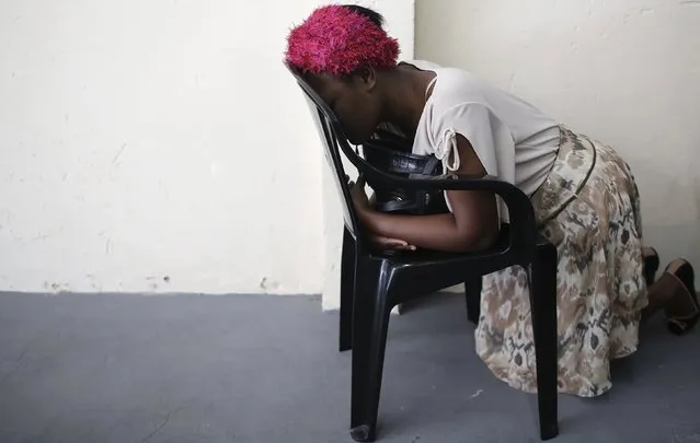 A Haitian immigrant prays during a mass in an evangelical church, at the Glicerio neighborhood of Sao Paulo May 24, 2015. Three years ago, the Brazil government announced the creation of a humanitarian visa that would be exclusively issued to Haitian refugees after the devastating 2010 earthquake on the island. (Photo by Nacho Doce/Reuters)