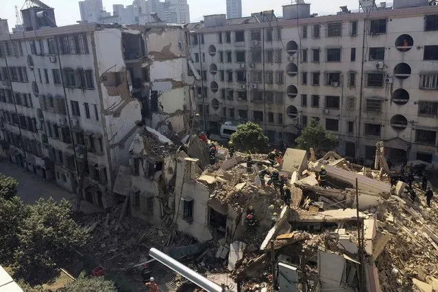 Rescuers carry out search and rescue operation on top of debris of a collapsed residential building in Fenghua, Zhejiang province April 4, 2014. (Photo by Reuters/China Daily)