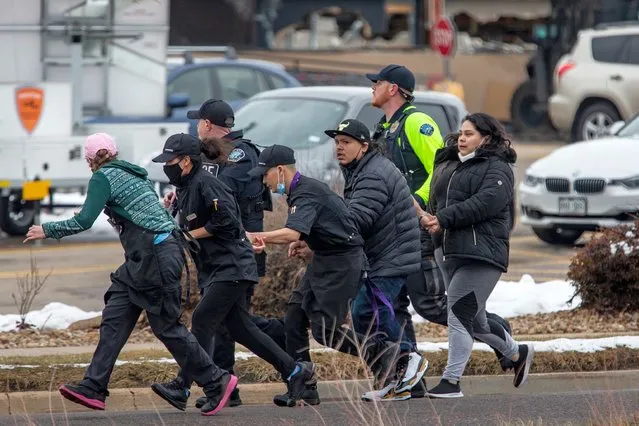 Shoppers are evacuated from a King Soopers grocery store after a gunman opened fire on March 22, 2021 in Boulder, Colorado. Dozens of police responded to the afternoon shooting in which at least one witness described three people who appeared to be wounded, according to published reports. (Photo by Chet Strange/Getty Images)
