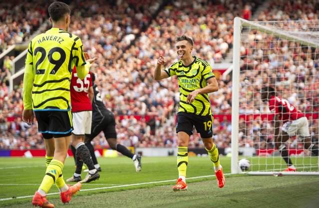 Leandro Trossard of Arsenal celebrates scoring the 0-1 goal with his teammtae Kai Havertz (L) who assisted the goal during the English Premier League soccer match between Manchester United and Arsenal in Manchester, Britain, 12 May 2024. (Photo by Peter Powell/EPA)