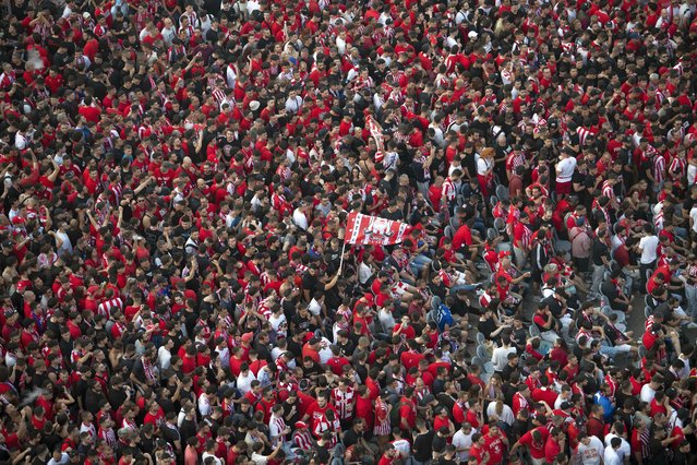 Olympiacos F.C. fans cheer for their team before the Conference League Final soccer match between Olympiacos and Fiorentina, in Piraeus, Greece, Wednesday, May 29, 2024. (Photo by Michael Varaklas/AP Photo)