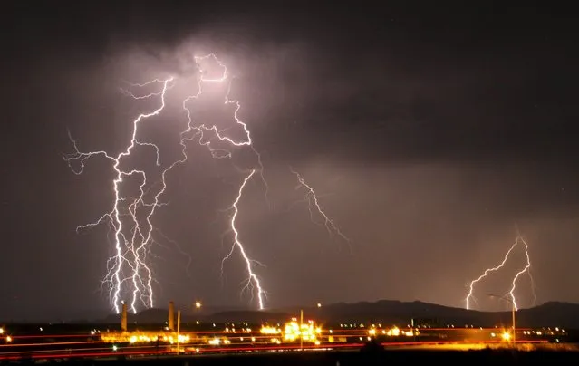 Mass lightning bolts light up night skies by Daggett airport from monsoon storms passing over the high deserts early Wednesday, north of Barstow, California, July 1, 2015. Picture taken using long exposure. (Photo by Gene Blevins/Reuters)