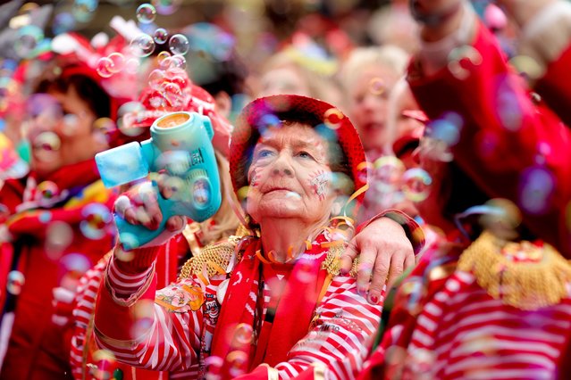 Costumed revelers celebrate the traditional “Weiberfastnacht” (Women's Carnival Day or Fat Thursday) carnival in Cologne, Germany, 16 February 2023. The Thursday of the 'Old Wives' heralds the beginning of the street carnival. (Photo by Friedemann Vogel/EPA)