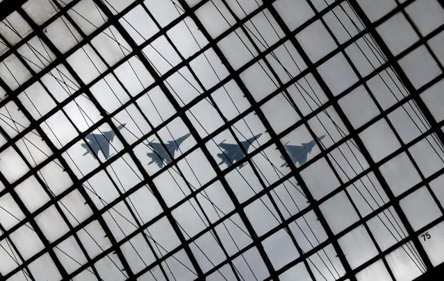 Russian Sukhoi Su-34 military jets are seen flying in formation through a glass roof of GUM department store during a rehearsal for the Victory Day parade to mark the 71st anniversary of the victory over Nazi Germany in World War Two, in Red Square in Moscow, Russia, May 5, 2016. (Photo by Grigory Dukor/Reuters)