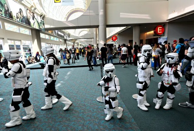 A group of young Star Wars Stormtroopers walk inside the Convention Center at the 2015 Comic-Con International in San Diego, California July 9, 2015. (Photo by Sandy Huffaker/Reuters)