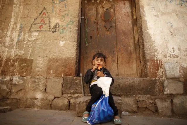 A girl sits outside a house during the first day of a ceasefire in Yemen's capital Sanaa April 11, 2016. (Photo by Khaled Abdullah/Reuters)