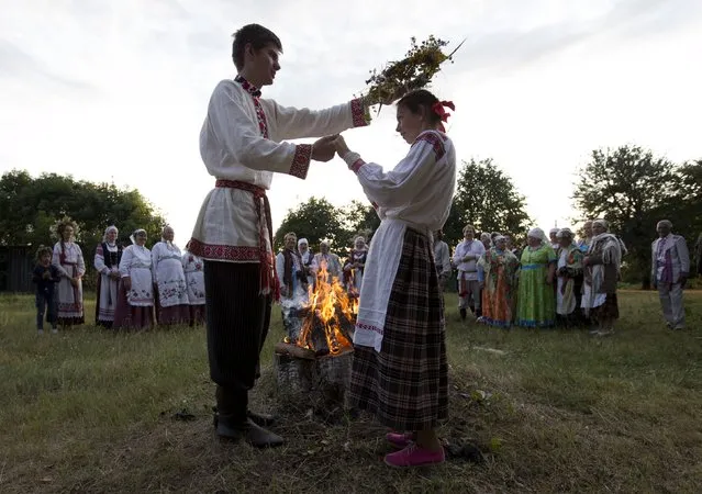 People take part in the festival of national traditions “Piatrovski” in the village of Shipilovichi, south of Minsk, July 12, 2015. (Photo by Vasily Fedosenko/Reuters)