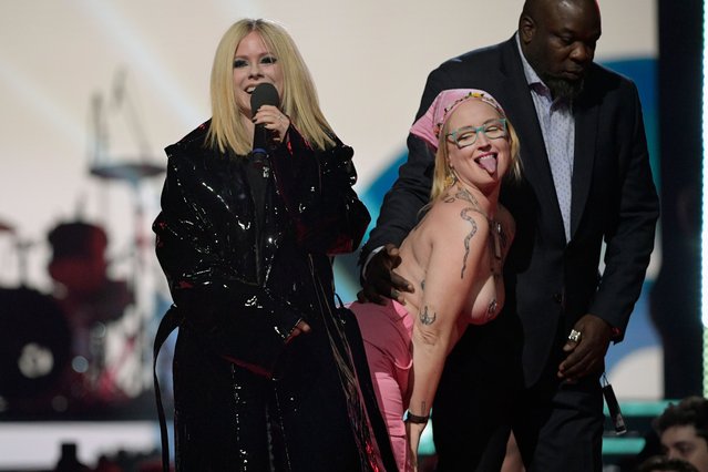 A protestor interrupts Canadian singer-songwriter Avril Lavigne speaking onstage at the 2023 JUNO Awards at Rogers Place on March 13, 2023 in Edmonton, Canada. (Photo by Dale MacMillan/Getty Images)