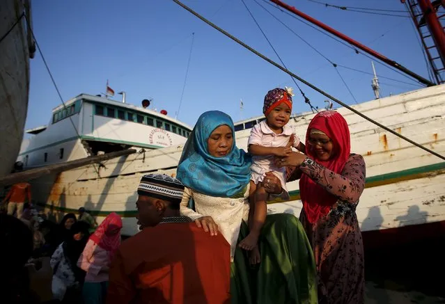 Muslims from a nearby neighbourhood arrive by boat to attend Eid al-Fitr prayers at Sunda Kelapa port in Jakarta, Indonesia July 17, 2015. (Photo by Darren Whiteside/Reuters)