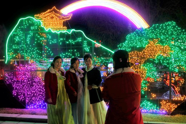 Citizens take a photo at a light festival in celebration of 110th birth anniversary of their late leader Kim Il Sung at Kim Il Sung Square in Pyongyang, North Korea Thursday, April 14, 2022. (Photo by Jon Chol Jin/AP Photo)