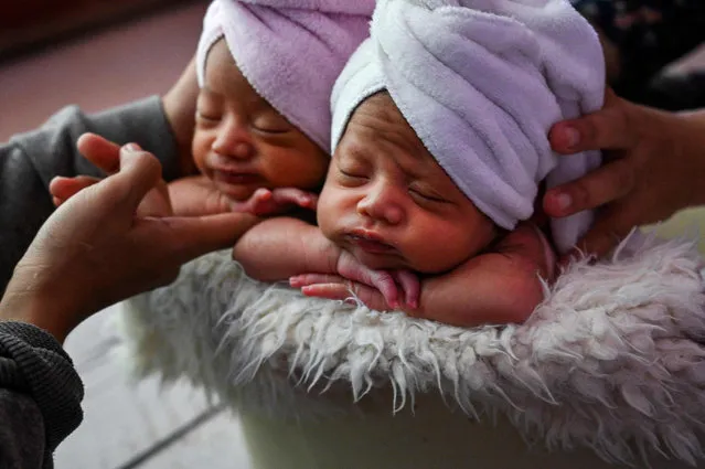 Twin are prepared for a newborn photo shoot by local photographer Fanny Nurdiana in Banda Aceh on March 18, 2022. (Photo by Chaideer Mahyuddin/AFP Photo)