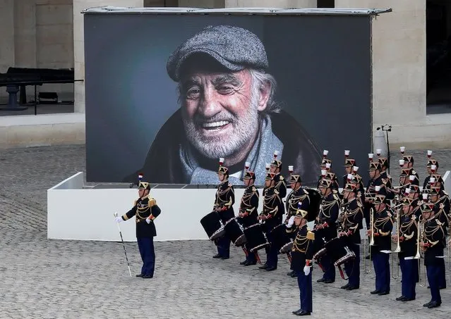 A photograph of late actor Jean-Paul Belmondo is seen on a giant screen during a ceremony at the Hotel des Invalides in Paris, France, September 9, 2021. (Photo by Eric Gaillard/Reuters)