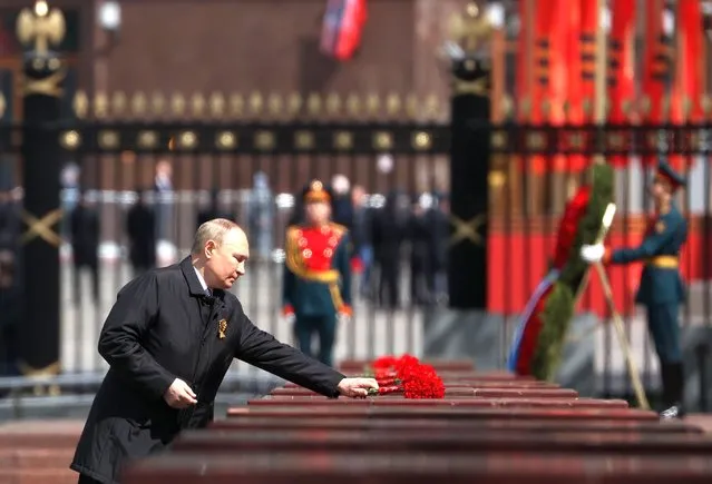 Russian President Vladimir Putin lays flowers at the Memorial to Hero Cities at the Tomb of the Unknown Soldier near the Kremlin wall after the Victory Day military parade in Moscow, Russia, 09 May 2022. Russia marks Victory Day, Nazi Germany's unconditional surrender in World War II, with the annual parade in Moscow's Red Square on 09 May, after more than two months of attacks on Ukraine. (Photo by Anton Novoderezhkin/Kremlin Pool/Sputnik/EPA/EFE)