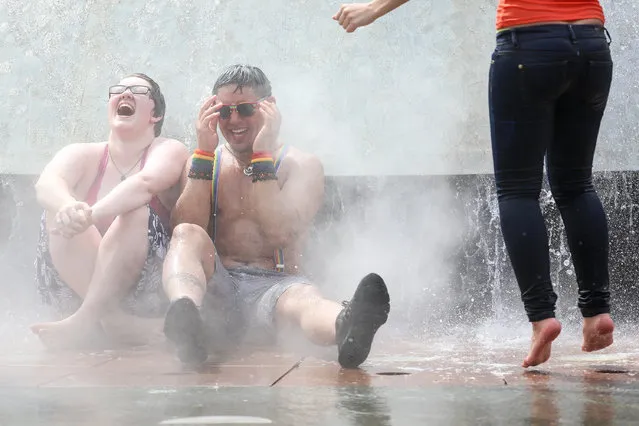Pride-goers cool down in the Seattle Center fountain following the 2014 Seattle Pride Parade on Sunday, June 29, 2014. (Photo by Joshua Bessex/AP Photo/Seattlepi.com)
