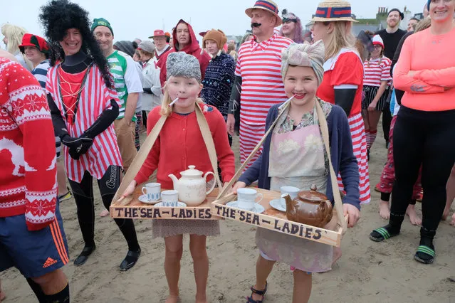 Hundreds turned out in fancy dress for the traditional New Year day “Lyme Lunge” race into the sea in Dorset, England on January 1, 2020. The annual event, on Dorset's Jurassic Coast, was watched by over a thousand spectators who gathered on Lyme Regis Cobb Beach to support the event. (Photo by Tom Corban/Rex Features/Shutterstock)