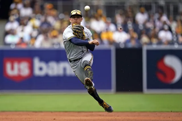 Milwaukee Brewers shortstop Luis Urias throws to first for the out on San Diego Padres' Jose Azocar during the third inning of a baseball game Wednesday, May 25, 2022, in San Diego. (Photo by Gregory Bull/AP Photo)
