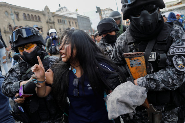 A demonstrator is detained by riot police during a protest, in La Paz, Bolivia on November 21, 2019. Bolivia's interim President Jeanine Anez asked Congress Wednesday to approve a law that would allow for new elections, after deadly unrest following the resignation of Evo Morales and the disputed October 20 ballot. (Photo by Marco Bello/Reuters)
