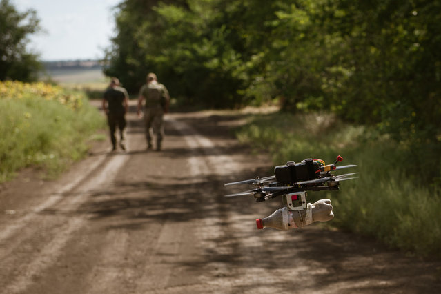 A FPV drone flies with a bottle full of sand during a military training near the Huliapole district of Zaporizhzhia in Ukraine on August 23, 2023. Ukrainian infantry and drone units, which perform both attack and surveillance purposes, continue their exercises at the Huliapole district of Zaporizhzhia. Huliaipole in Southern Ukraine, is about 5 km from the Russian positions, has been a front-line city for more than a year. As the attack on the Southern Front developed and advanced in the city, the attacks with artillery and planes has increased. (Photo by Andre Alves/Anadolu Agency via Getty Images)