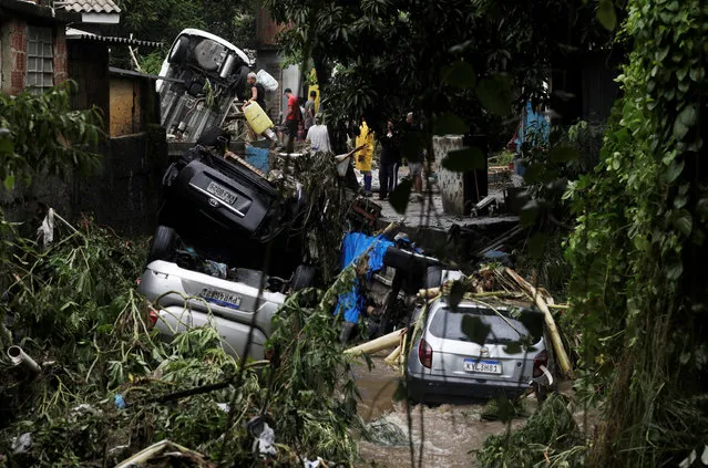 Residents try to recover belongings at a damaged area in Realengo neighborhood after heavy rains in Rio de Janeiro, Brazil on March 2, 2020. (Photo by Ricardo Moraes/Reuters)